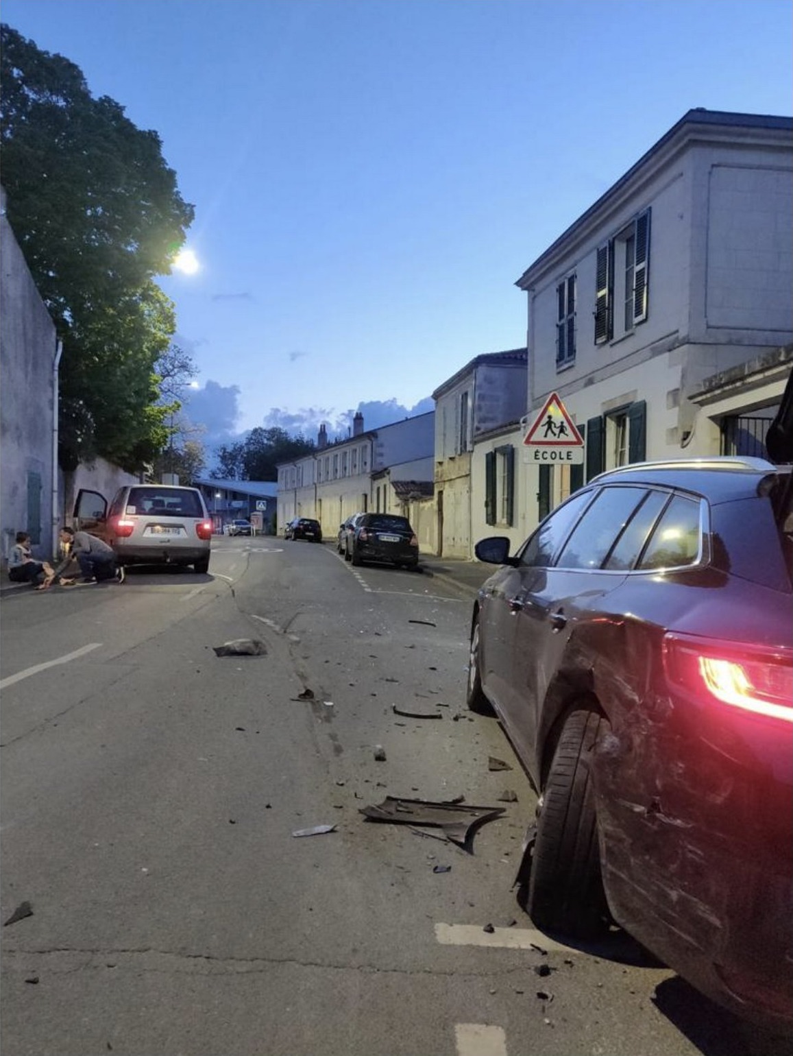 Scène d'accident de nuit rue Marius-Lacroix, débris au sol, panneau École visible